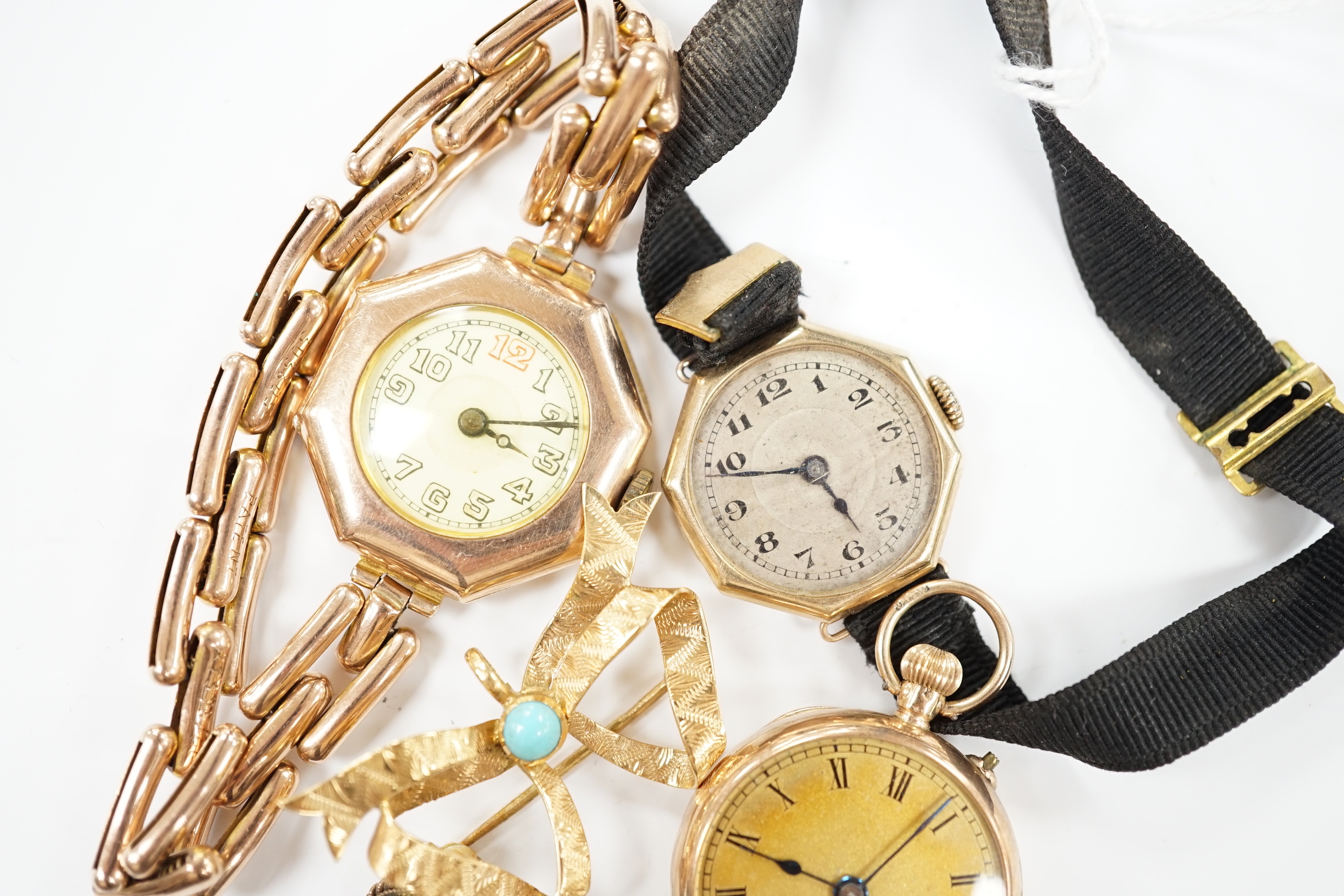 Two early 20th century 9ct gold manual wind wrist watches, one on an expanding 9ct bracelet, a 9ct gold fob watch, a 750 and turquoise set 'butterfly' shaped ribbon bow brooch and a stick pin.